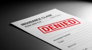 March 28, 2026 | Unfair Claims and Settlement Practices Four men in suits discussing together.