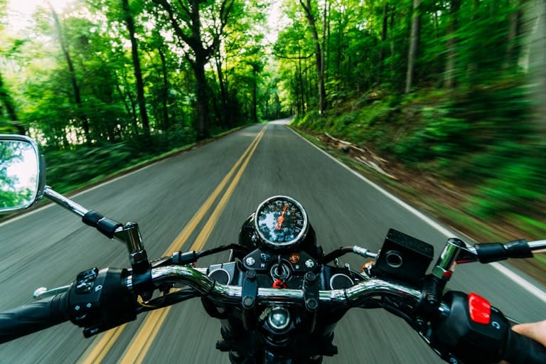 Motorcycle ride through a scenic, winding road.
