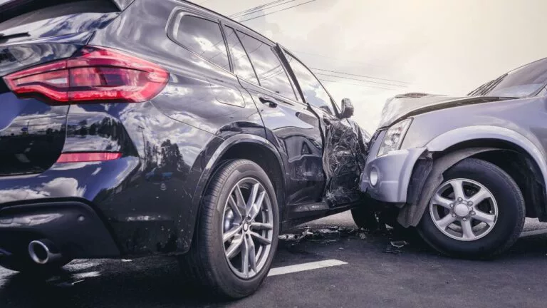 Damaged rental vehicle and a police cruiser at the scene of an accident