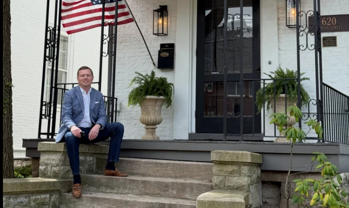 Jonathan Hollan seated on the front steps outside the Lexington office.