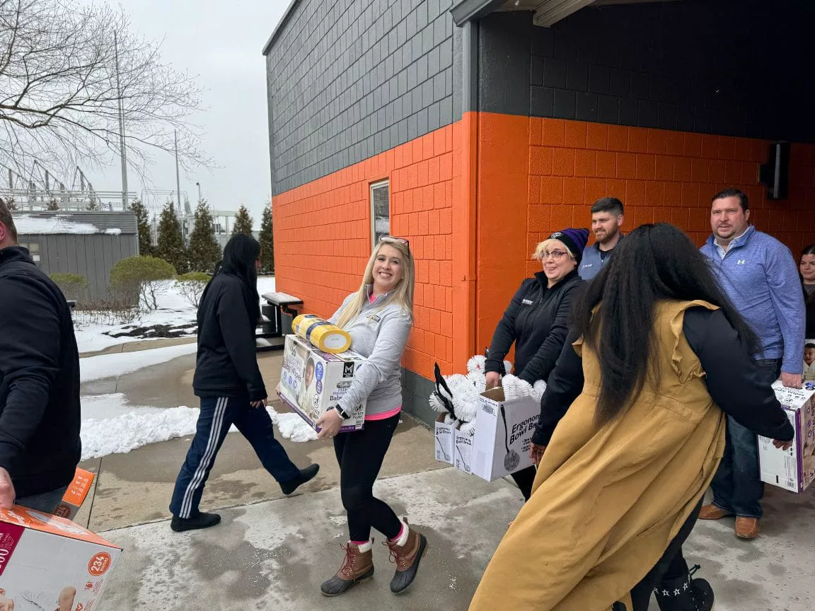 Sam Aguiar Injury Lawyers team carrying donated supplies