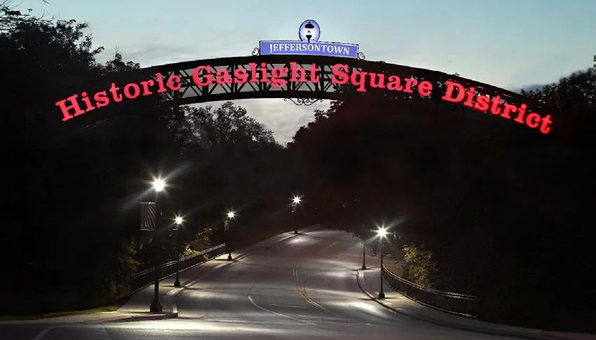 Jeffersontown historic gaslight square district arch above a street at dusk