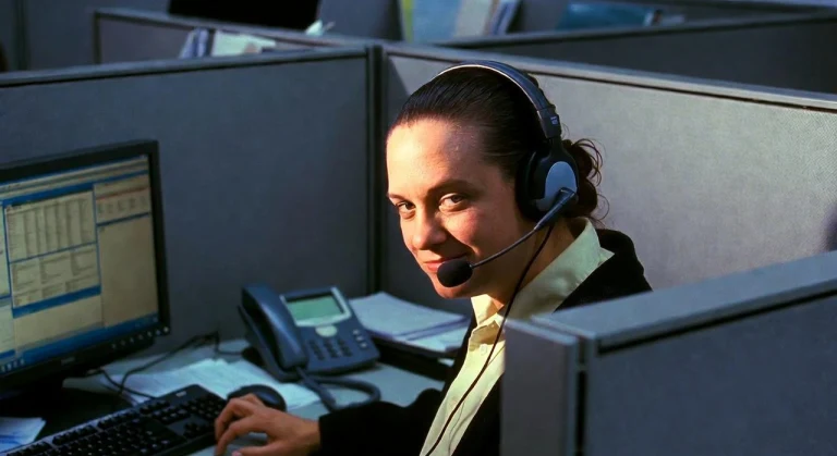 Woman wearing a headset at an office computer