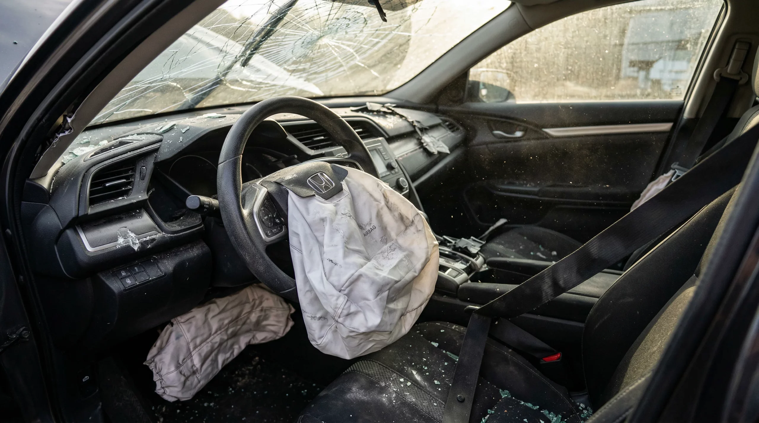 Seat belt across a driver's chest in the driver's seat of a vehicle, showing how the shoulder belt loads the ribcage during frontal impact
