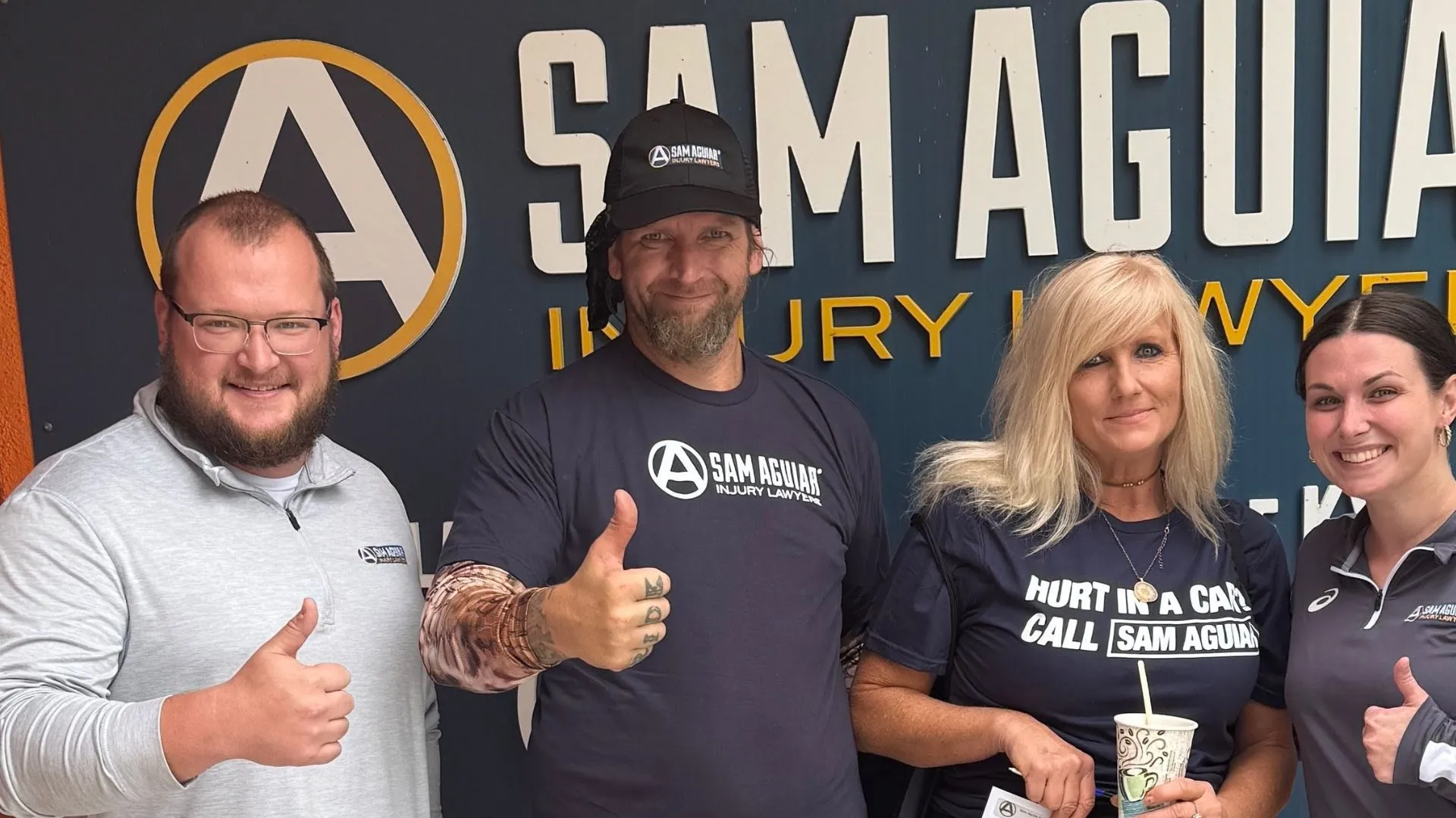 Clients with sam aguiar injury lawyers after case resolution
