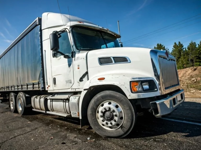 White semi-truck parked on road