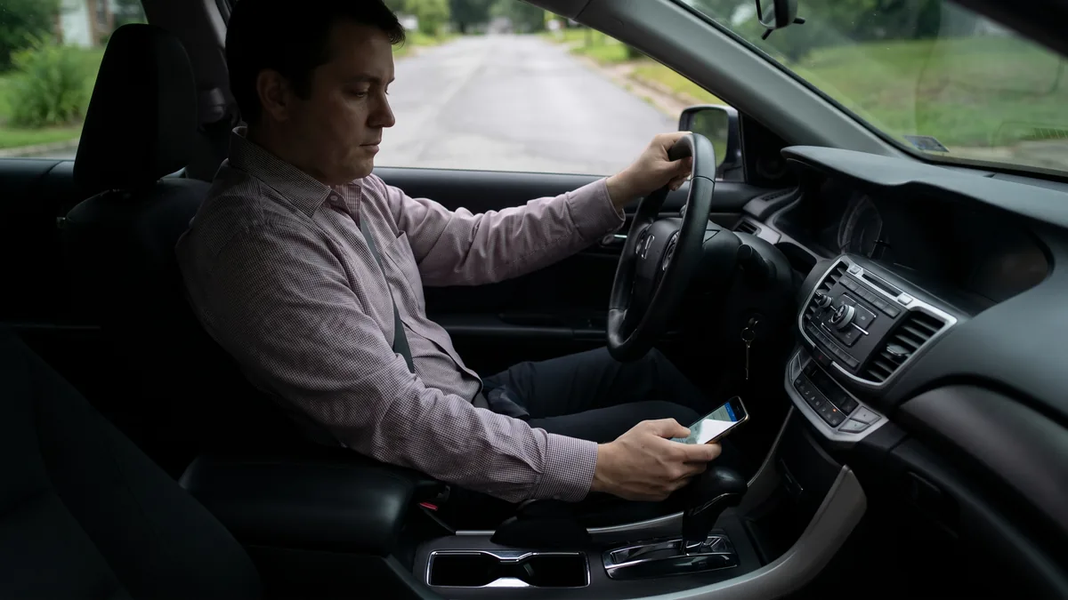 Driver looking at a cell phone while behind the wheel under kentucky hands-free driving law