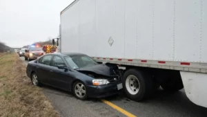 Car crushed under the rear of a semi-truck trailer in an underride crash