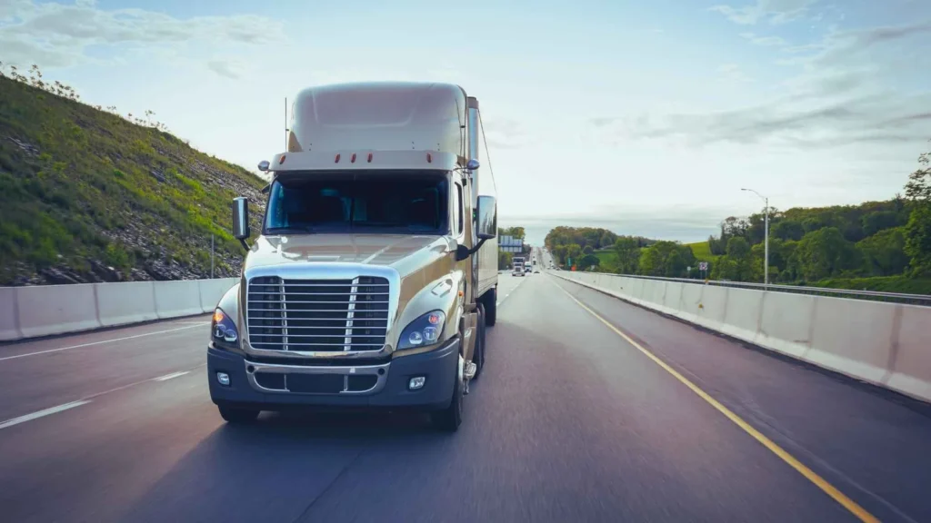 White 18-wheeler traveling on a Kentucky highway