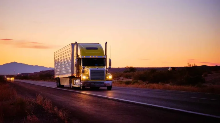 18-wheeler truck traveling a kentucky highway at sunset