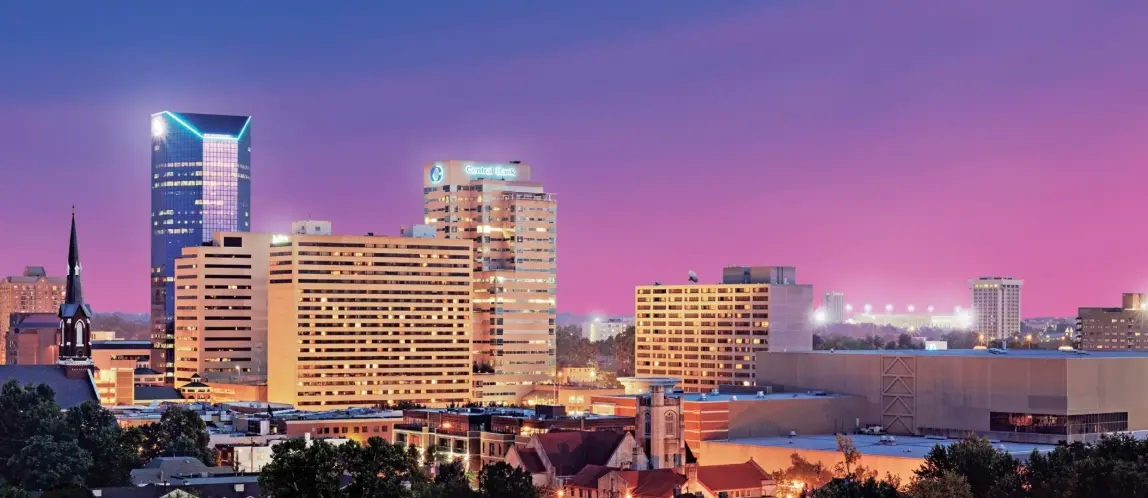 Downtown Lexington skyline at dusk with a pink and purple sky