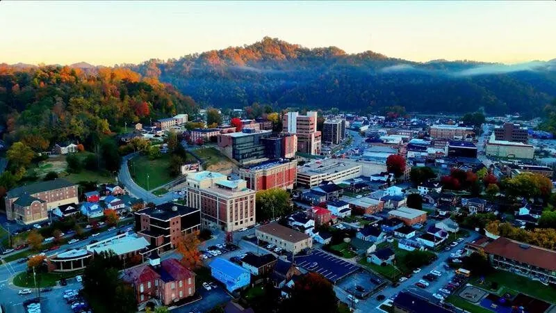 Downtown Pikeville from above, with autumn trees and mountain ridges behind it