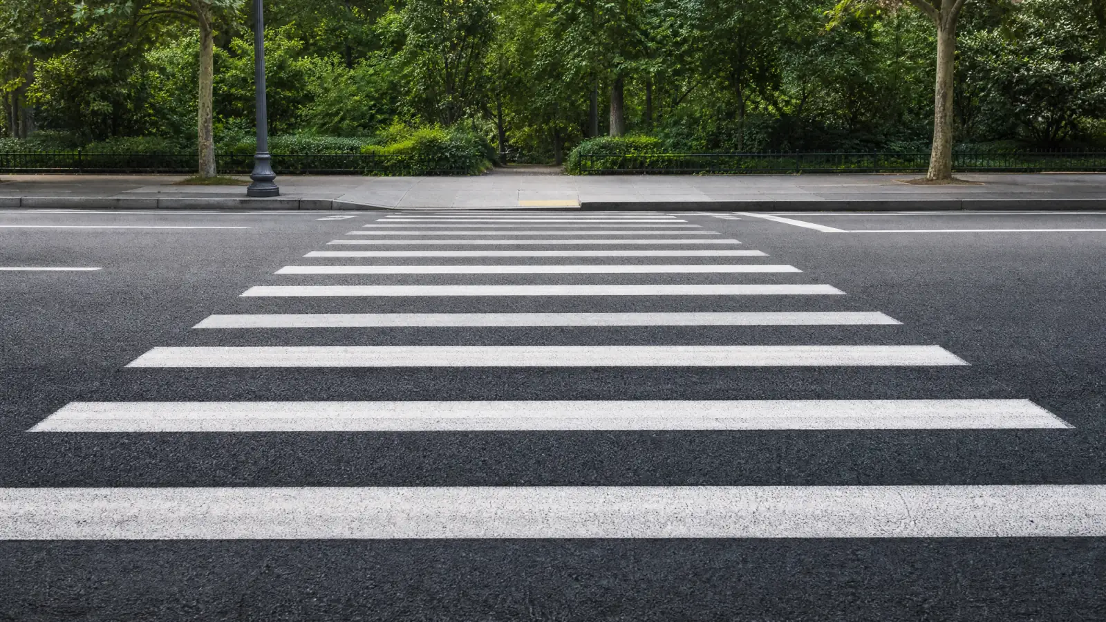 White crosswalk stripes painted across an empty street