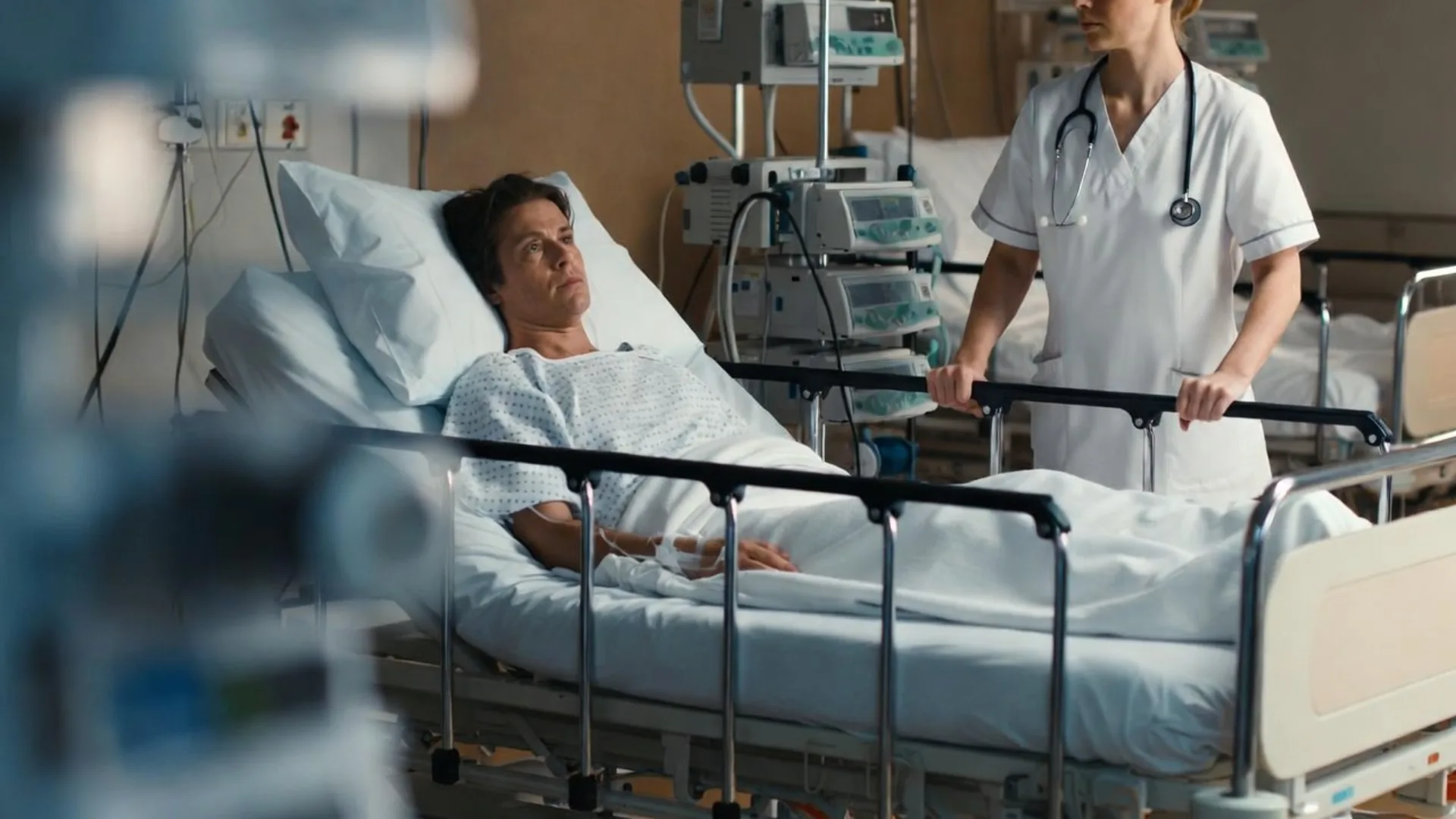 Injured patient in a hospital bed with a nurse after a car accident