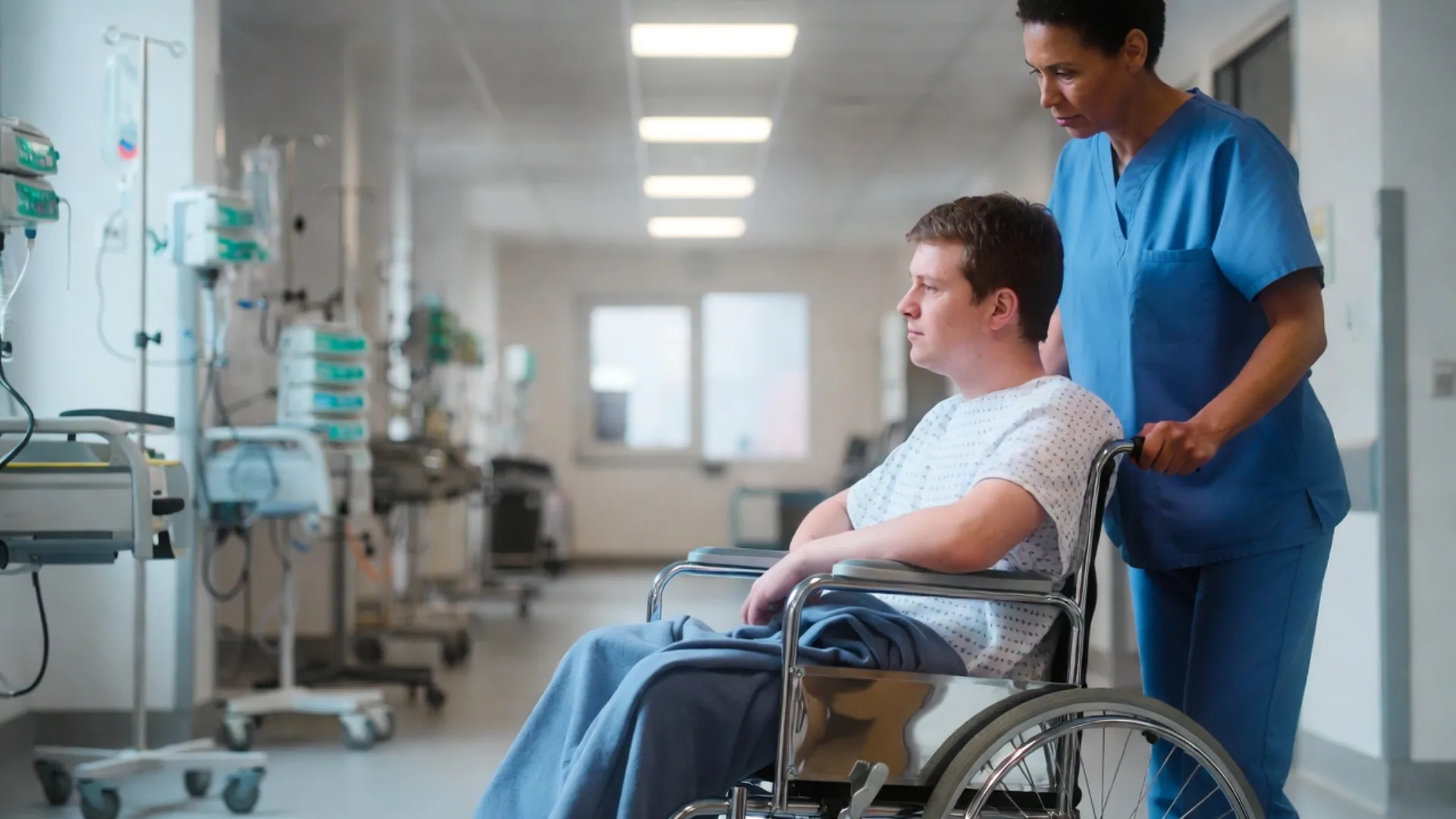 Spinal cord injury patient in a wheelchair being assisted by a nurse