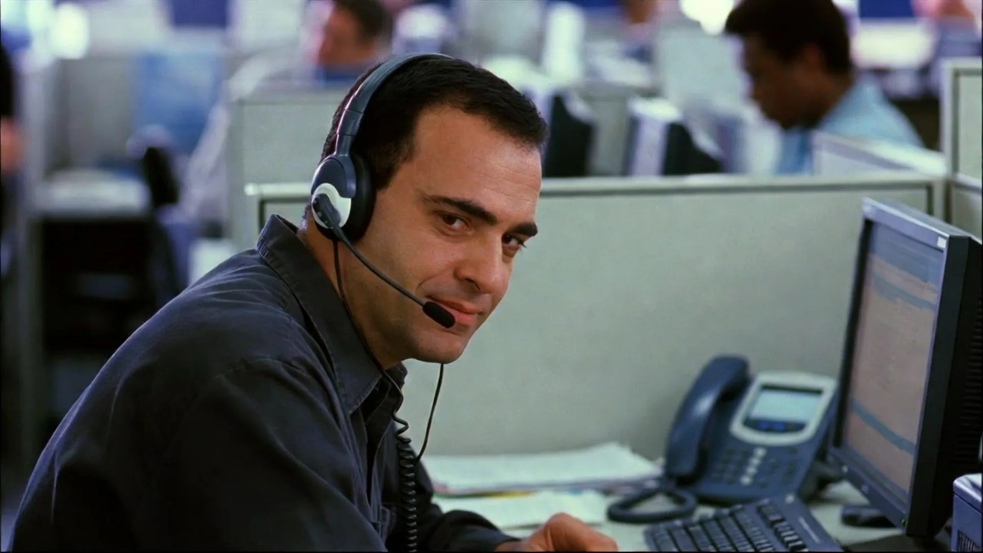 Insurance call-center adjuster on a headset using tactics to minimize a claim