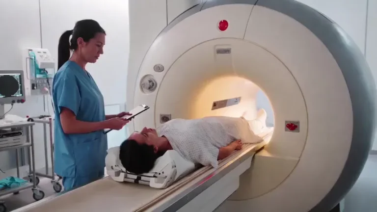 Radiology technologist guiding a patient into an MRI scanner
