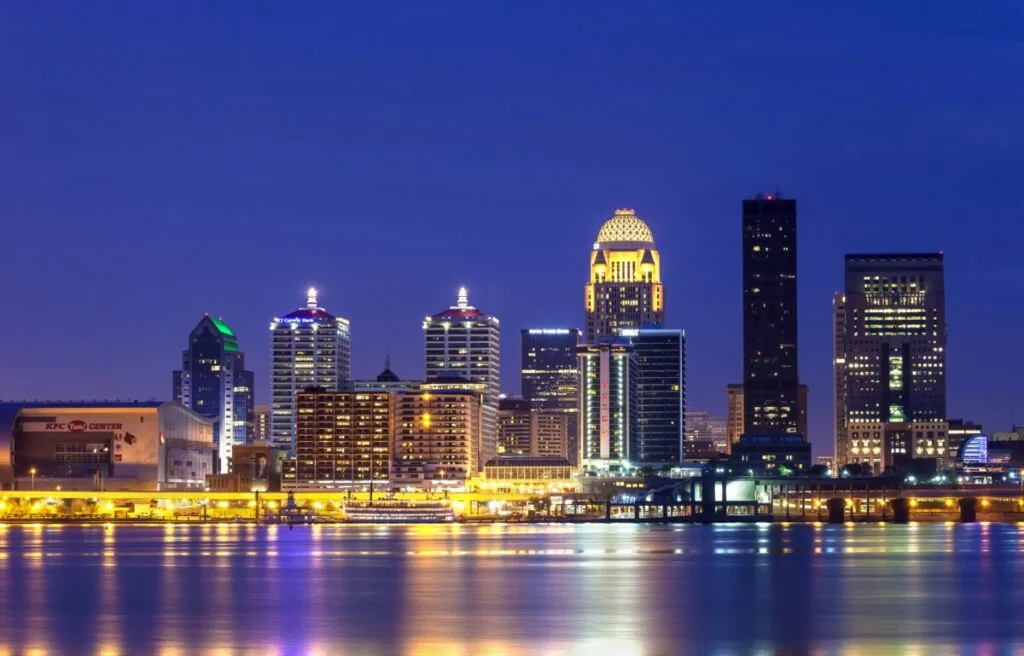Louisville skyline with ohio river reflections near the yum center