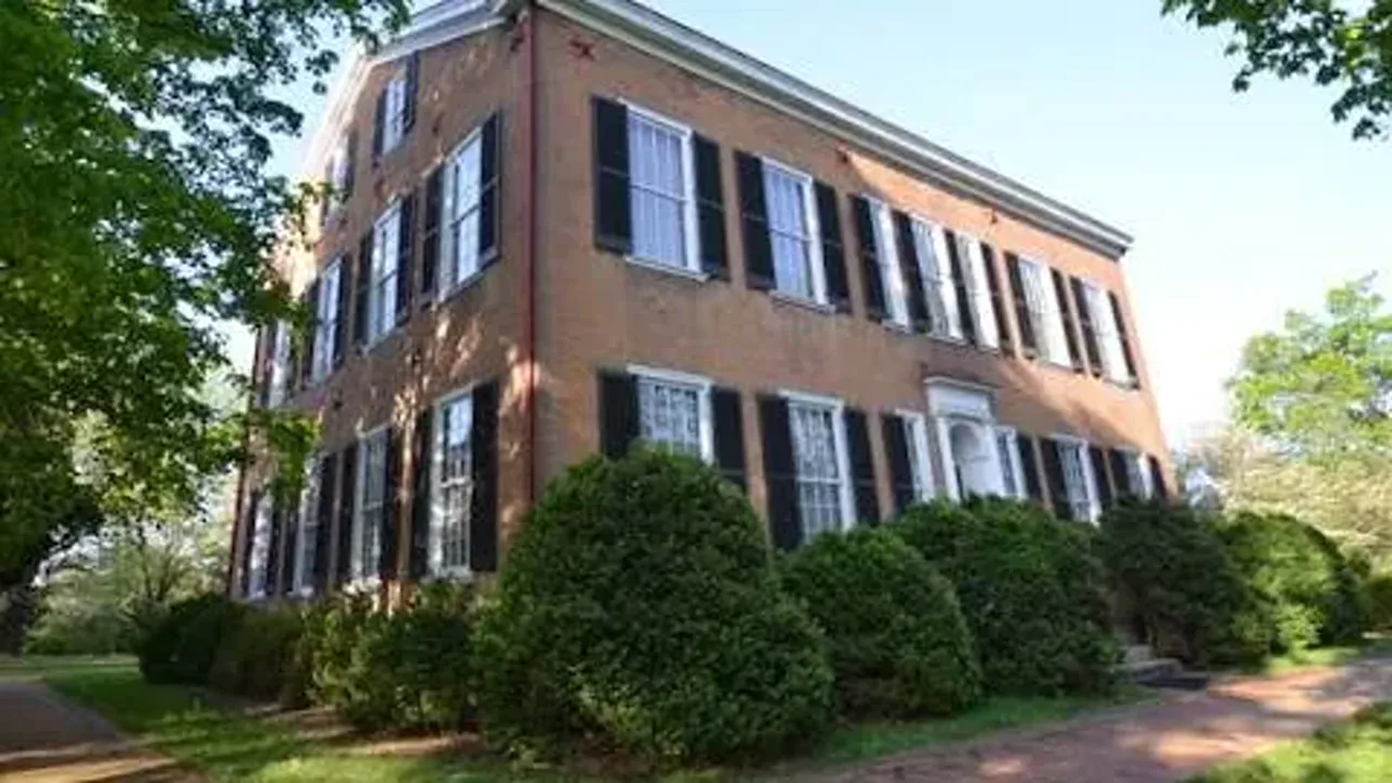 Historic brick building with white shutters in Bardstown, Kentucky