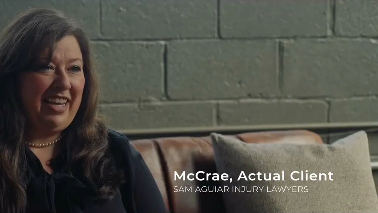 McCrae seated in front of a gray brick wall with the caption McCrae, Actual Client