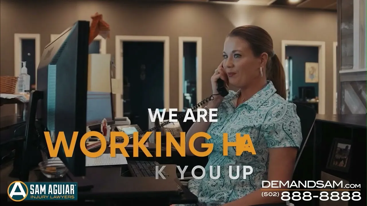 Woman on a phone call at an office desk beside on-screen text and the firm’s phone number