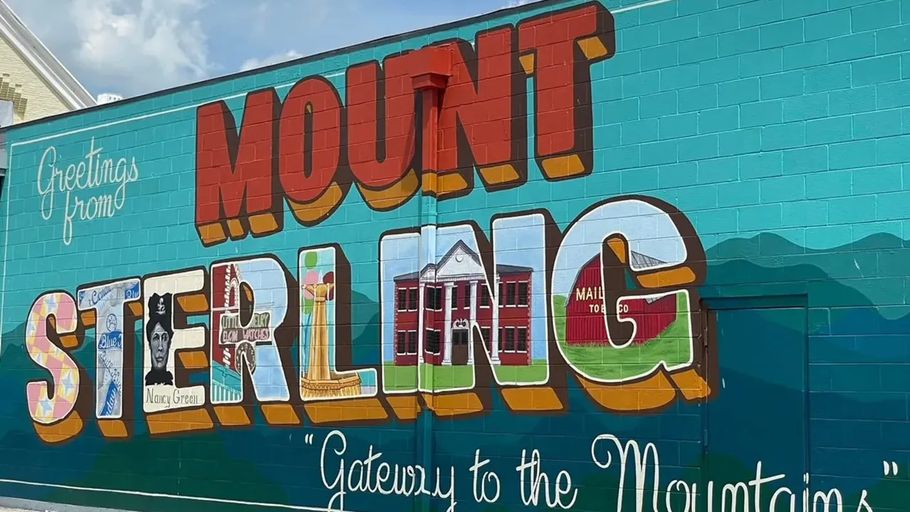Colorful Mt. Sterling mural on a turquoise brick wall