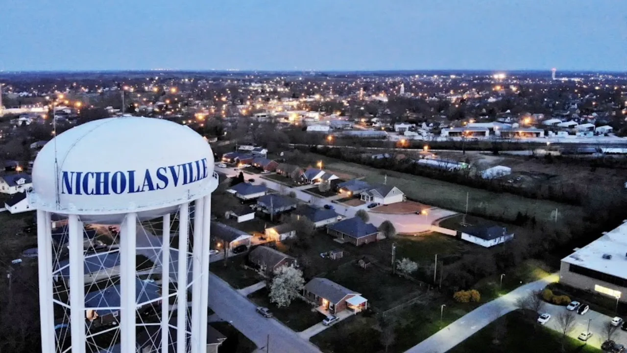 Aerial view of Nicholasville, Kentucky at dusk with the city water tower in the foreground
