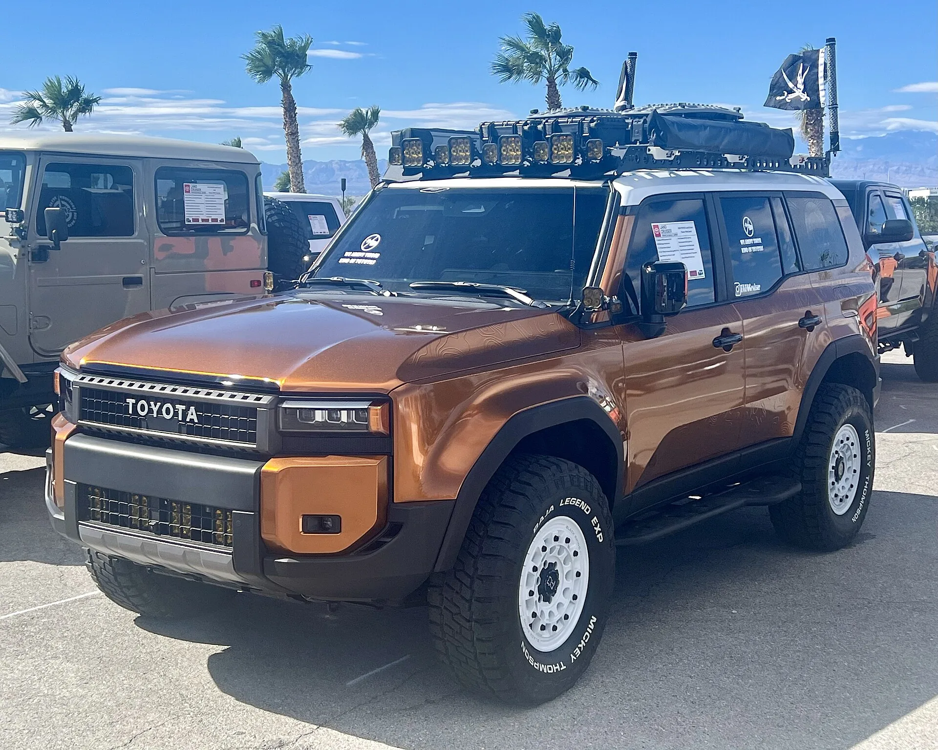 Toyota Land Cruiser with aftermarket equipment at an outdoor vehicle display